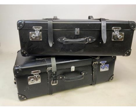 A pair of Globe Trotter large leather suitcase with leather straps, wheels and stamped locking mechanism. RRP Ã‚Å3600. W:82cm