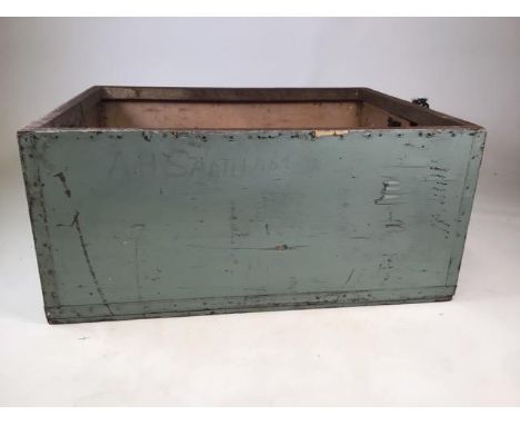 A painted wooden open top trunk with rope carrying handles