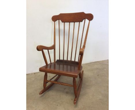 A Modern pine stick back rocking chair. W:59cm x D:75cm x H:103cm