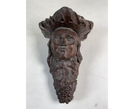 An antique carved oak wall sconce or bracket of a lady with grapes.W:17cm x D:17cm x H:25cm