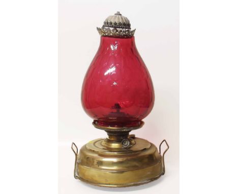 Victorian brass oil lamp with large ruby glass shade. Condition report: see terms and conditions