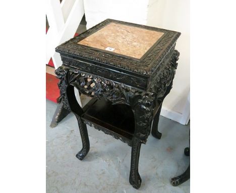 A fine 19th century carved oriental rosewood, marble topped vase stand with ornate, all over carved frame, lower shelf on car