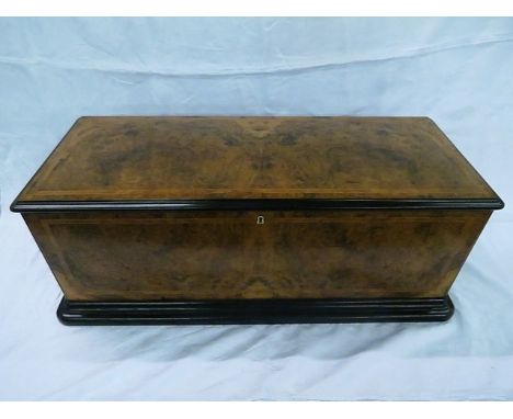 A large walnut cased Swiss musical box with bells and drums, playing thirty six airs, with a fitted case housing the remainin