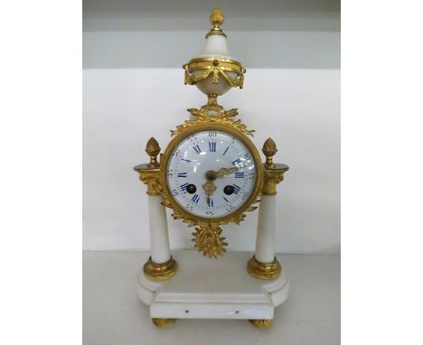 A 19th century French white marble and gilt metal mantle clock having an enamel dial on raised feet 
