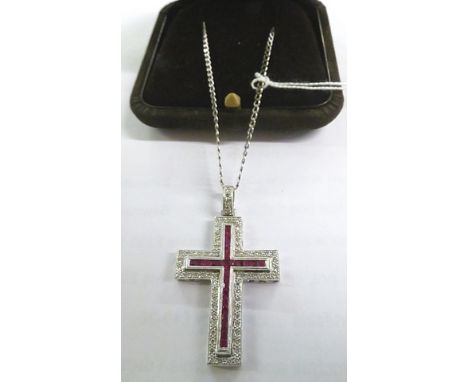 An 18ct white gold Cartier style ruby and brilliant cut diamond cross on a white gold chain 