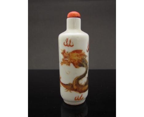 A 19th Century Chinese porcelain snuff bottle with top.  Painted with a dragon chasing the flaming pearl.  Vendor purchased t