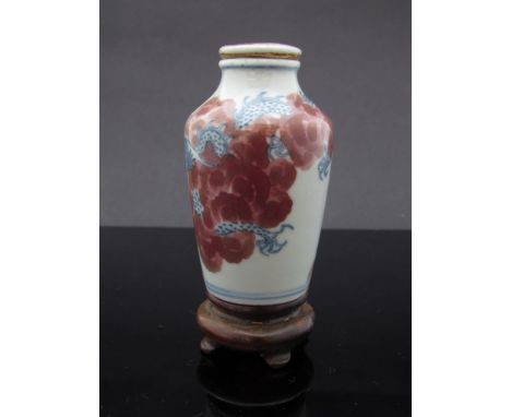 An early 19th Century fine Chinese porcelain snuff bottle of cylindrical form with a slightly pinched neck set with original 