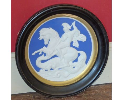 Circular ceramic plaque depicting Romanesque horse-rider slaying a Dragon. Condition reports are not available for Interiors 