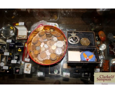 A tin containing various coinage; and a cash tin containing a Light Infantry badge and various others 