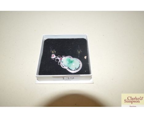 A white metal and jade coloured stone set pendant 