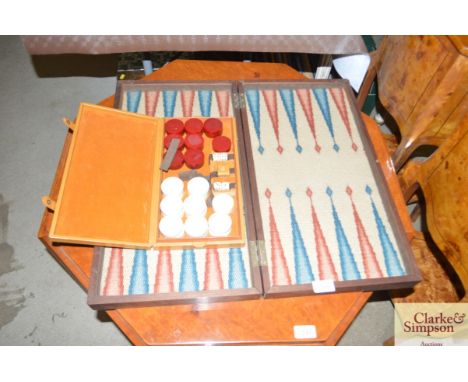 A mahogany cased bagatelle board; and box of bagatelle pieces and dice 