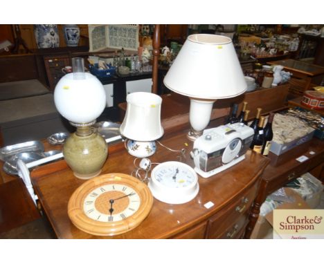 A Scotts of Stow CD radio system; two wall clocks; two table lamps; and a pottery oil lamp