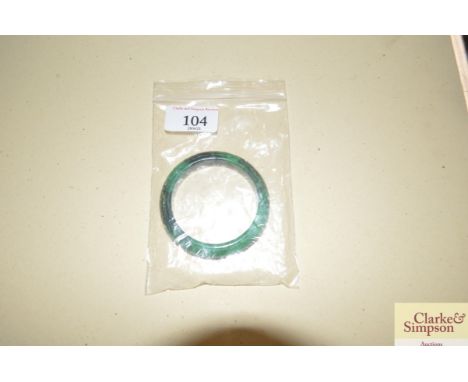A carved jade type bangle 
