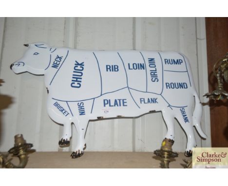 An enamel cow sign 