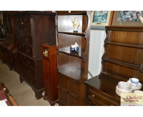 A dark Ercol corner cabinet 