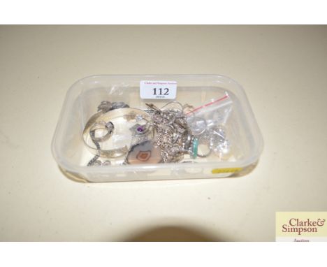 A box containing a silver bangle and various silver and white metal jewellery to include rings, brooch etc.