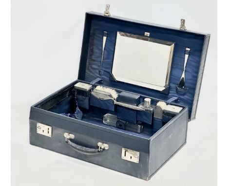 A 1937 Art Deco silver vanity set in case. 51x33x16cm