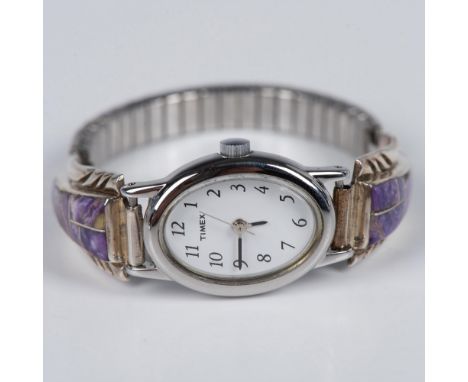 Beautiful Southwest Native American piece. The watch has a Speidel silver expansion band and sides inlaid with purple charoit