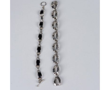 Two sterling silver bracelets inlaid with black enamel and stamped 925. The first measures 7.75"L and weighs 14g. The second 