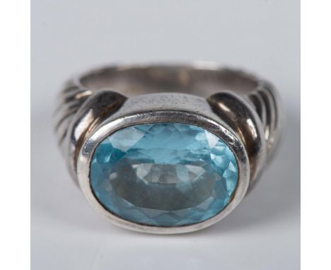 Sterling silver band stamped 3J925 with a large oval light blue topaz stone. 18g, size 9. Condition: Age related wear.