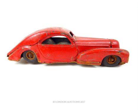 A vintage post war, German red, tin plate, wind up car; 25cm; a/f.