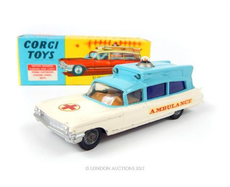 A Corgi Toys Superior Ambulance on Cadillac Chassis 437 in blue and cream with operational light (cannot guarantee its contin