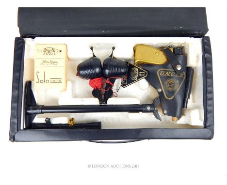 A retro toy Man from U.N.C.L.E. secret agent attache case including a pistol in holster; two toy 'walkie talkies'; cigarette 