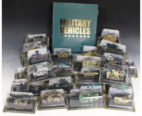 A COLLECTION OF TWENTY EIGHT 1:72 SCALE MODELS OF MILITARY VEHICLES, all in boxes, with a related folder of magazinesBuyers -