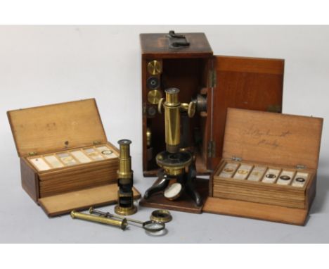 A CASED LATE 19TH CENTURY LACQUERED BRASS MICROSCOPE AND SPARE LENS, marked 'Baker, 244 High Holborn, London', along with an 