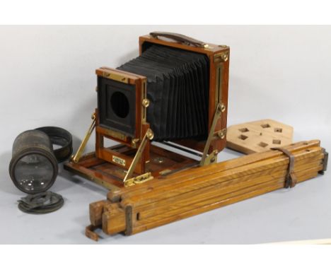 A TEAK AND BRASS 'GANDOLFI' 5" x 4" STUDIO CAMERA, and wooden tripod standBuyers - for shipping pricing on this lot, visit ww