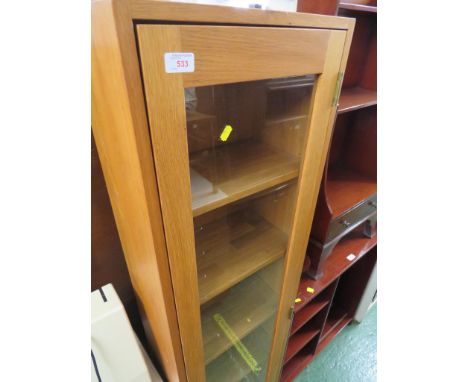 NARROW LIGHT OAK DISPLAY CABINET WITH GLAZED DOOR AND FIVE INTERNAL SHELVES.