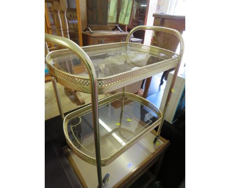 A VINTAGE TUBULAR METAL TEA TROLLEY. *