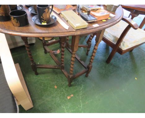 SMALL OAK OVAL GATE LEGGED TABLE WITH BARLEY TWIST SUPPORTS.