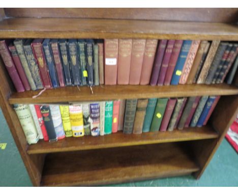 TWO SHELVES OF ANTIQUE AND VINTAGE FICTION BOOKS.
