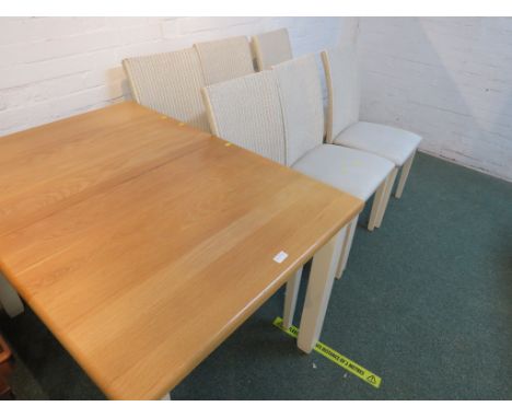 A LIGHT WOOD TOPPED EXTENDING DINING TABLE TOGETHER WITH SIX WOVEN BACK AND WHITE UPHOLSTERED DINING CHAIRS.