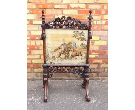 VICTORIAN CARVED OAK FIRESCREEN WITH GLAZED PETIT POINT PANEL WITH A GIRL ON A HORSE, MAN AND THREE DOGS, IN A LANDSCAPE, WIT