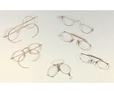 A PAIR OF ANTIQUE CONTINENTAL GOLD PINCE-NEZ STAMPED 14 K, GROSS 11.6 GRAMS AND FIVE PAIRS OF GILT METAL SPECTACLE FRAMES (6)
