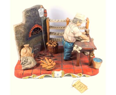 CAPODIMONTE PORCELAIN MODEL, THE BAKERY, AN INTERIOR WITH A BAKER AT A TABLE KNEADING DOUGH, ON A PLINTH BASE, SIGNED R. GUID