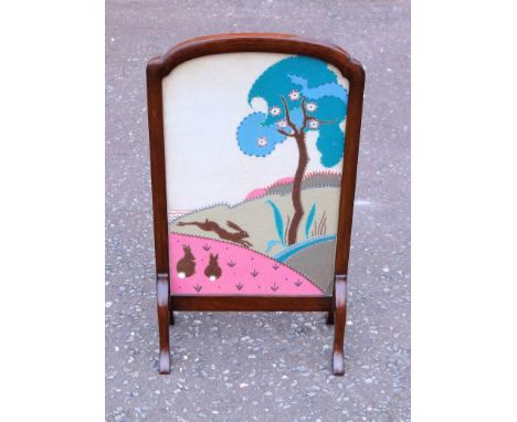 ARTS &amp; CRAFTS MAHOGANY FIRESCREEN WITH A GLAZED TEXTILE COLLAGE PANEL OF TWO RABBITS, HARE AND A FLOWERING TREE IN A LAND