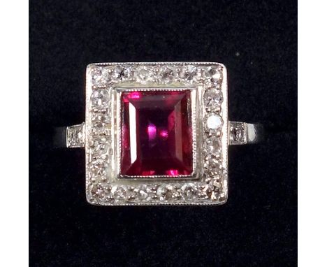 WHITE METAL RING SET RECTANGULAR CUT RUBY STONE 7 X 6 MM AND TWENTY FOUR DIAMONDS, STAMPED 'PLAT', GROSS 2.9 GRAMS. 