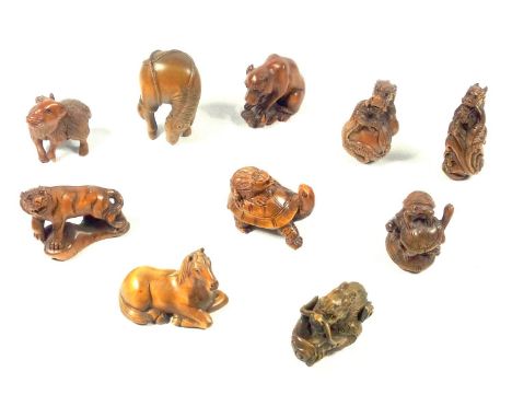 JAPANESE CARVED WOOD NETSUKE IN THE FORM OF A WATER BUFFALO, STANDING (H. 4.5 CM) AND NINE OTHER NETSUKE OF ANIMALS, ALL SIGN