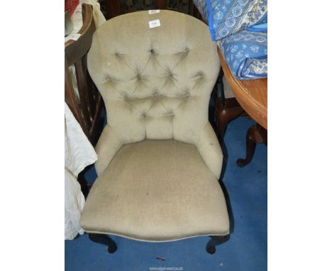 A small button back bedroom chair.