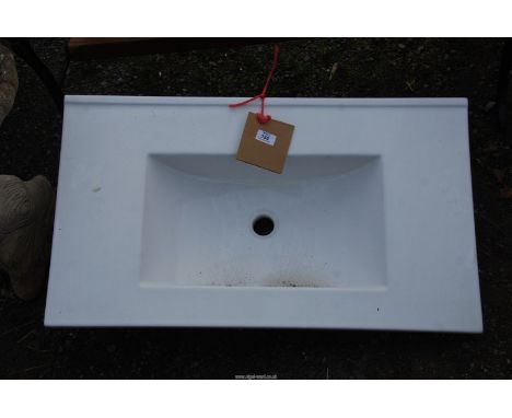 A ceramic sink, 32" wide x 18" depth.