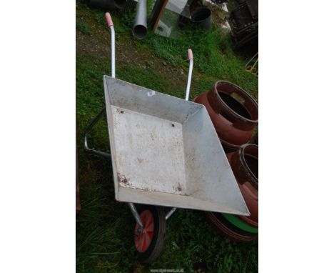 A galvanized wheelbarrow with solid tyre (as new).