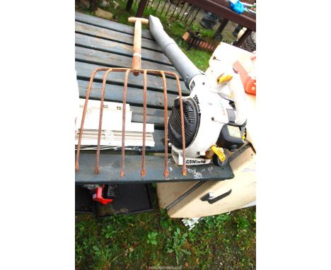 A "Ryobi" petrol driven garden blower (NEEDS ATTENTION)  and a beet fork.