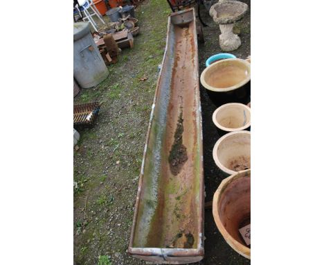 A galvanized wheeled sheep trough, 9' long.