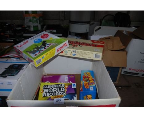 A box of games including Twister, Scrabble, Monopoly, etc.