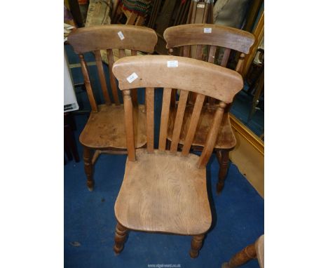 Three stick back kitchen chairs.