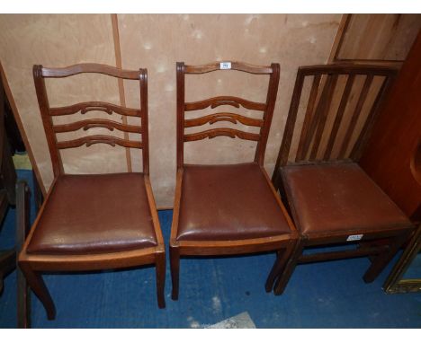 A pair of dining chairs plus a stick back dining chair, all with leather drop-in seats.