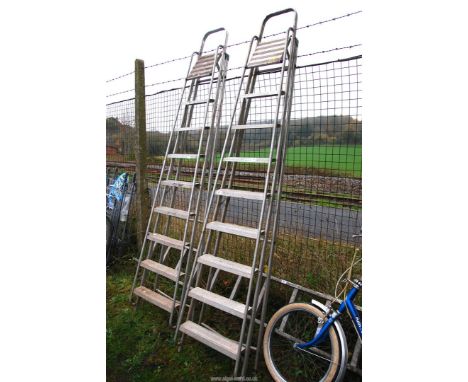 Two nine rung folding aluminium step ladders.